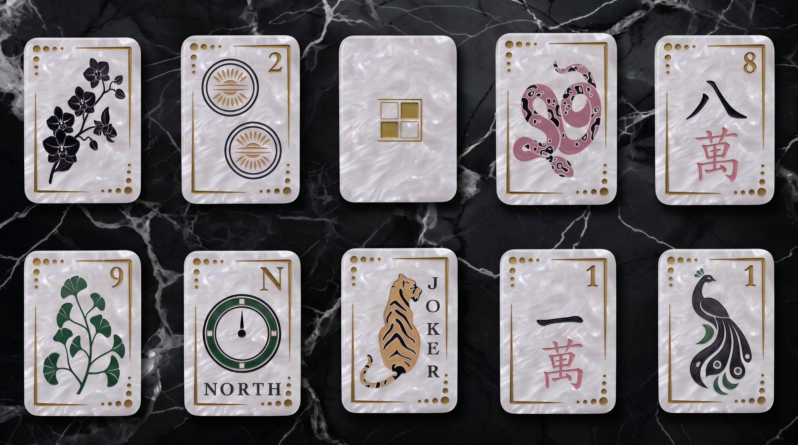Ten Luxe Glam tiles arranged on black marble — orchid, two dot, the ivory pearl back, snake, eight wan, nine bamboo, North wind, Tiger Joker, one wan, peacock.