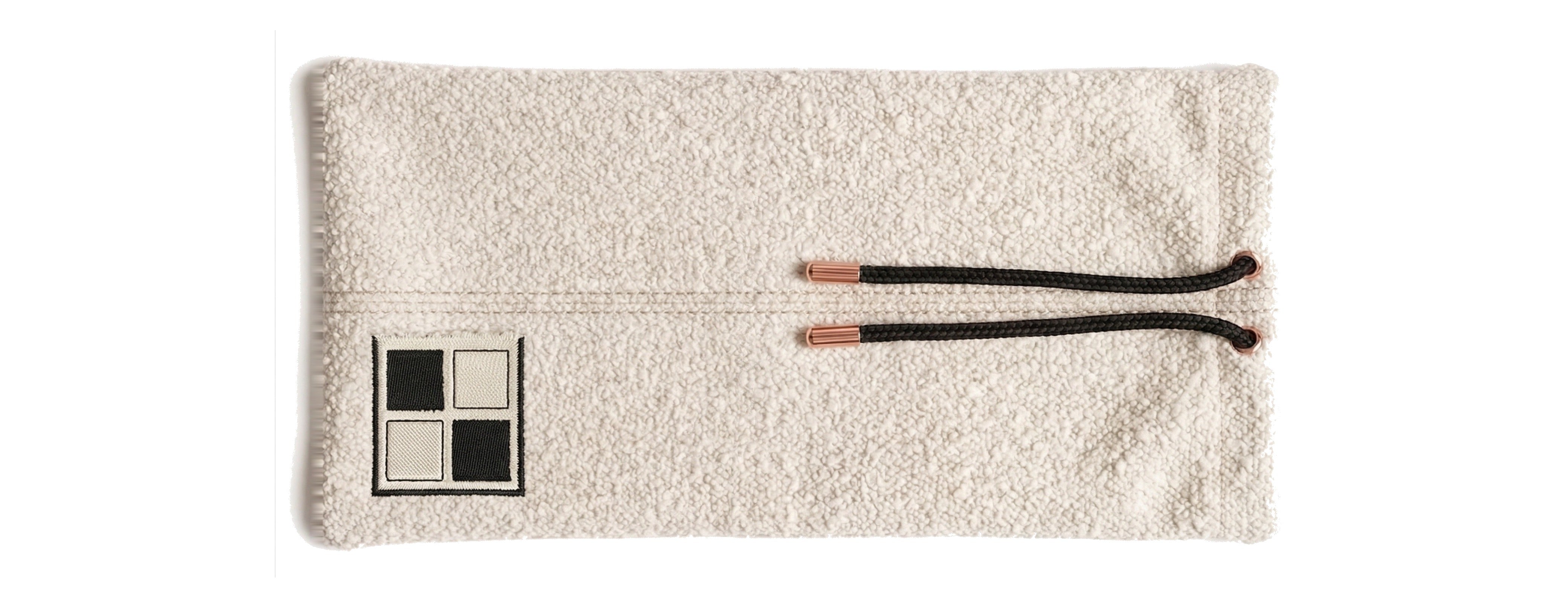 Ivory bouclé rack pouch with rose-gold drawstring tips and embroidered Mise en Mahjong patch.