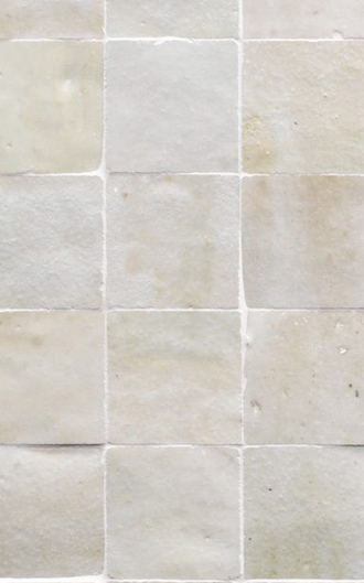 Cream-glazed zellige limestone tile wall with hand-made variation