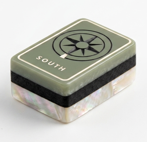 Sage green Mise en Mahjong South Wind tile with compass-rose glyph on mother-of-pearl base