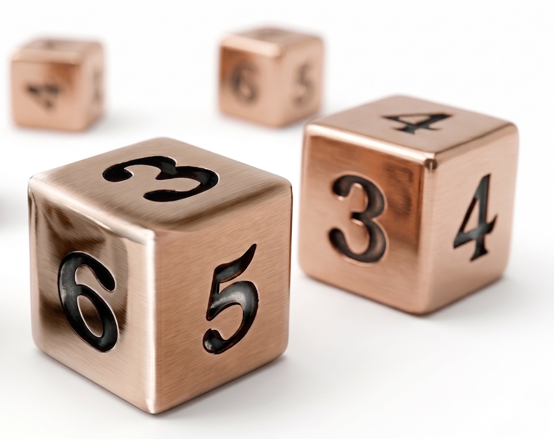 Three brushed copper mahjong dice.